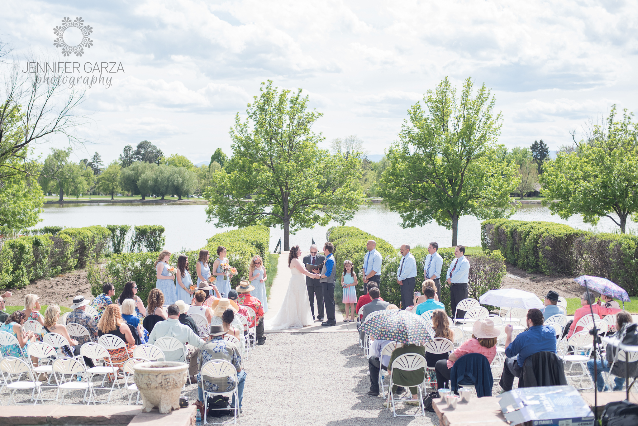 Bride & Groom exchanging vows during a summer wedding ceremony in the park. Rachael & Wes' Wash Park and Irish Rover Pub Denver Wedding by Colorado Wedding Photographer, Jennifer Garza. Colorado Wedding Photographer, Denver Wedding Photographer, Colorado Wedding Photos, Denver Wedding Photos, Colorado Bride, Denver Bride, Wash Park Wedding, Wash Park, Irish Rover Pub, Irish Rover Pub Wedding, Pub Wedding, Park Wedding