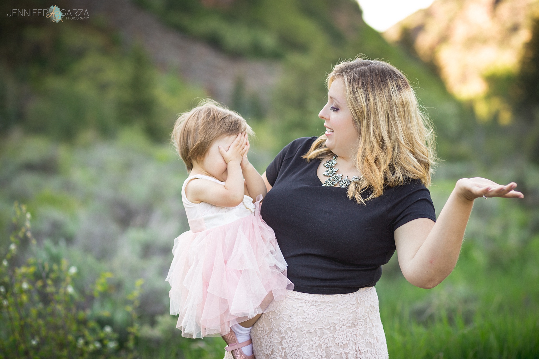 Annie & Savannah playing Peek-A-Boo during their family photo session near Vail, Colorado.