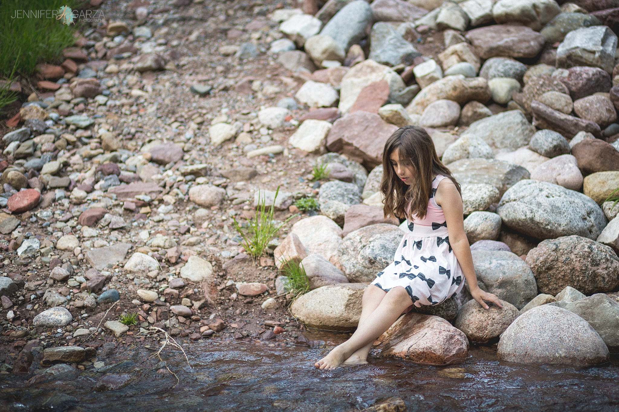 Rhyanne playing in the creek during their Sylvan Lake family photo session.