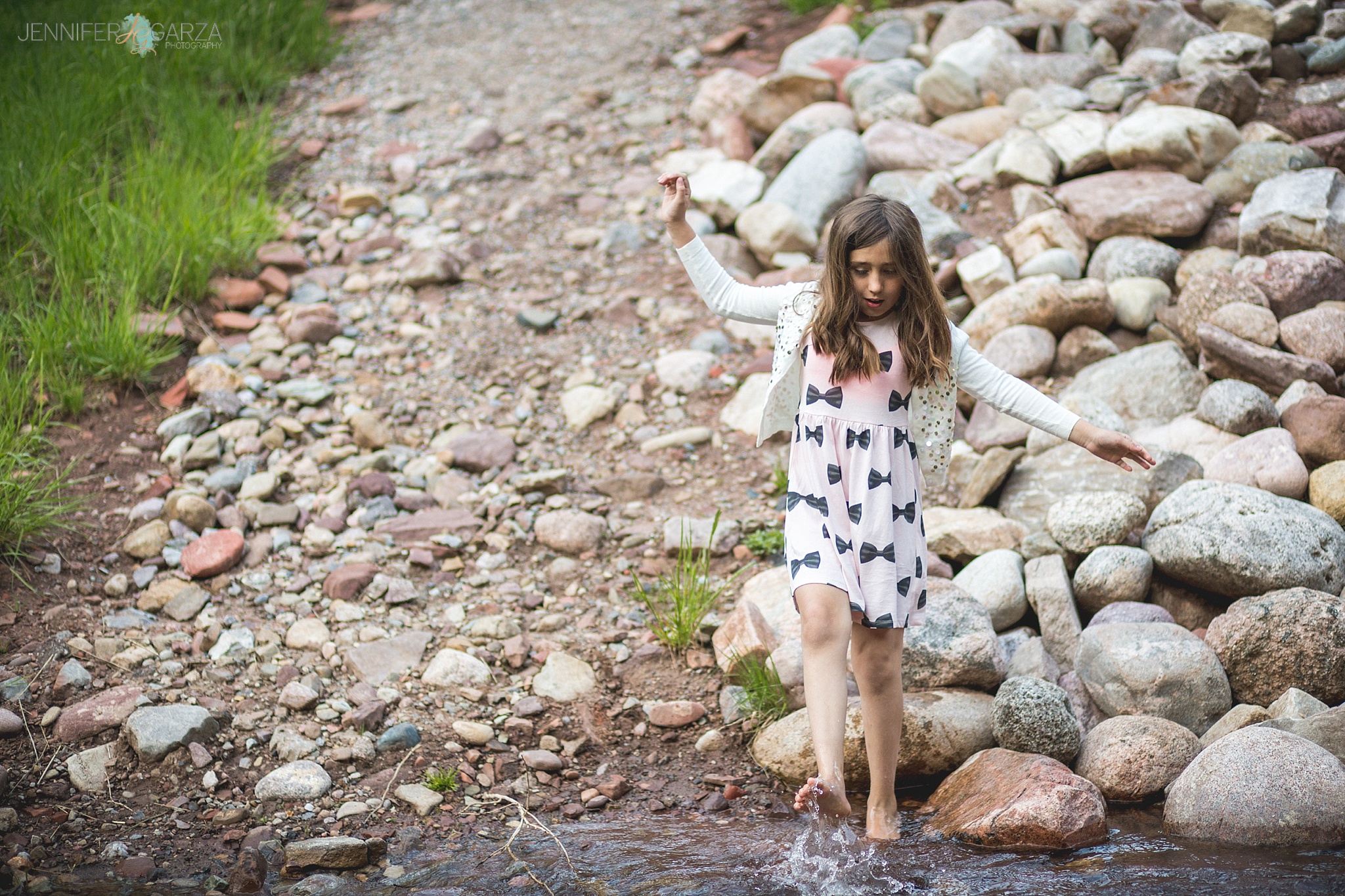 Rhyanne playing in the creek during their Sylvan Lake family photo session.