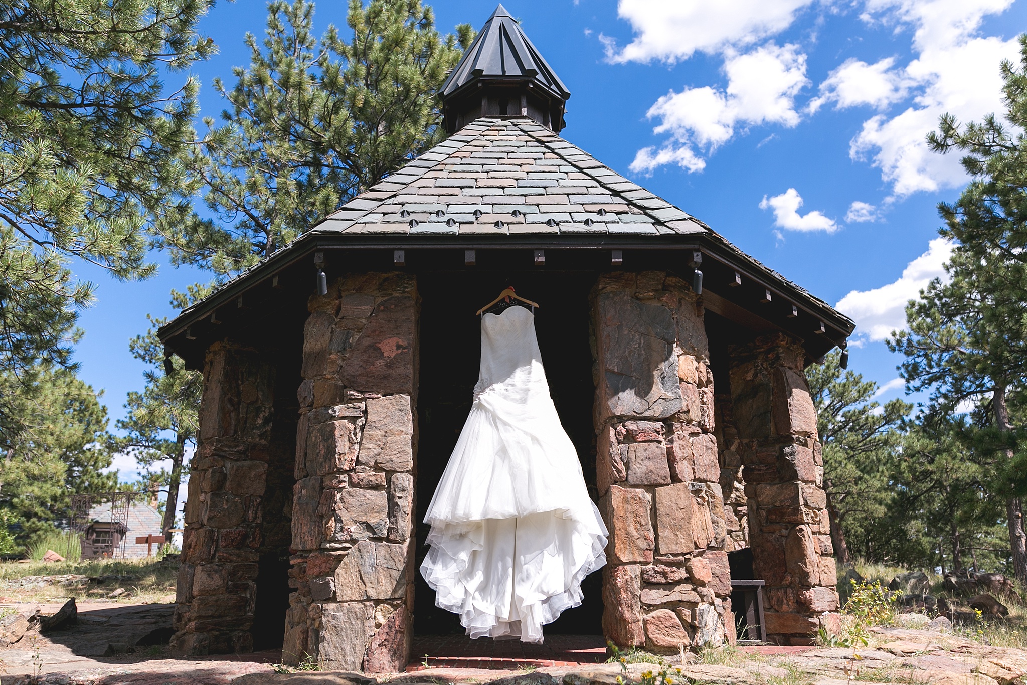 Bride’s dress hanging up in gazebo. Kellie & Brian’s Colorado Mountain Wedding at the historic Boettcher Mansion by Colorado Wedding Photographer, Jennifer Garza. Colorado Wedding Photographer, Colorado Wedding Photography, Colorado Mountain Wedding Photographer, Colorado Mountain Wedding, Mountain Wedding Photographer, Boettcher Mansion Wedding Photographer, Boettcher Mansion Wedding, Mountain Wedding, Lookout Mountain Wedding Photographer, Golden Wedding Photographer, Colorado Bride