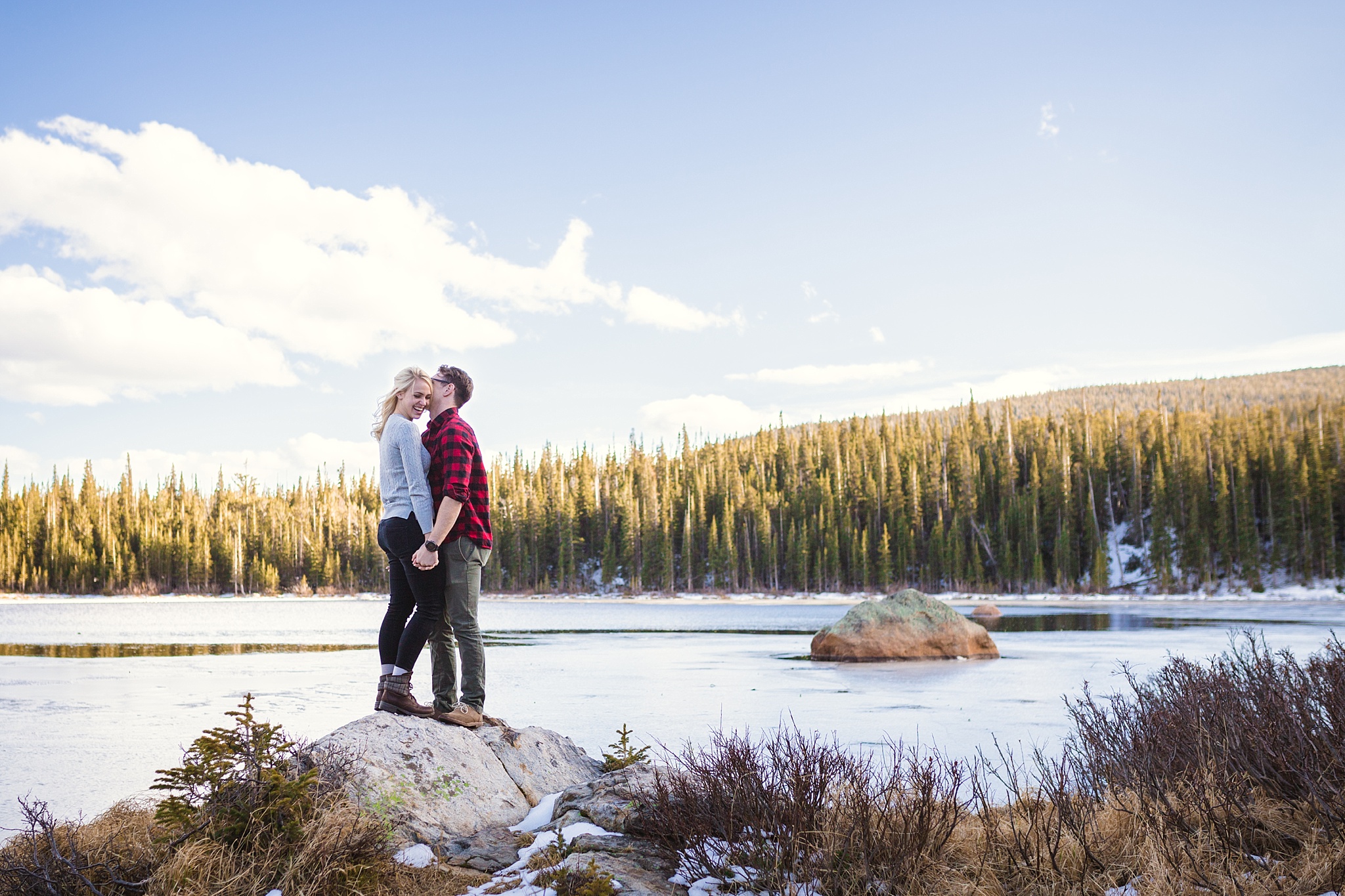 Man kissing his fiancé playfully with a lake and mountain views during their Colorado engagement session. Amy & Jonathan’s Brainard Lake Winter Engagement Session by Colorado Engagement Photographer, Jennifer Garza. Colorado Engagement Photographer, Colorado Engagement Photography, Brainard Lake Engagement Session, Brainard Lake Engagement Photos, Mountain Engagement Session, Colorado Winter Engagement Photos, Winter Engagement Photography, Mountain Engagement Photographer, Colorado Wedding