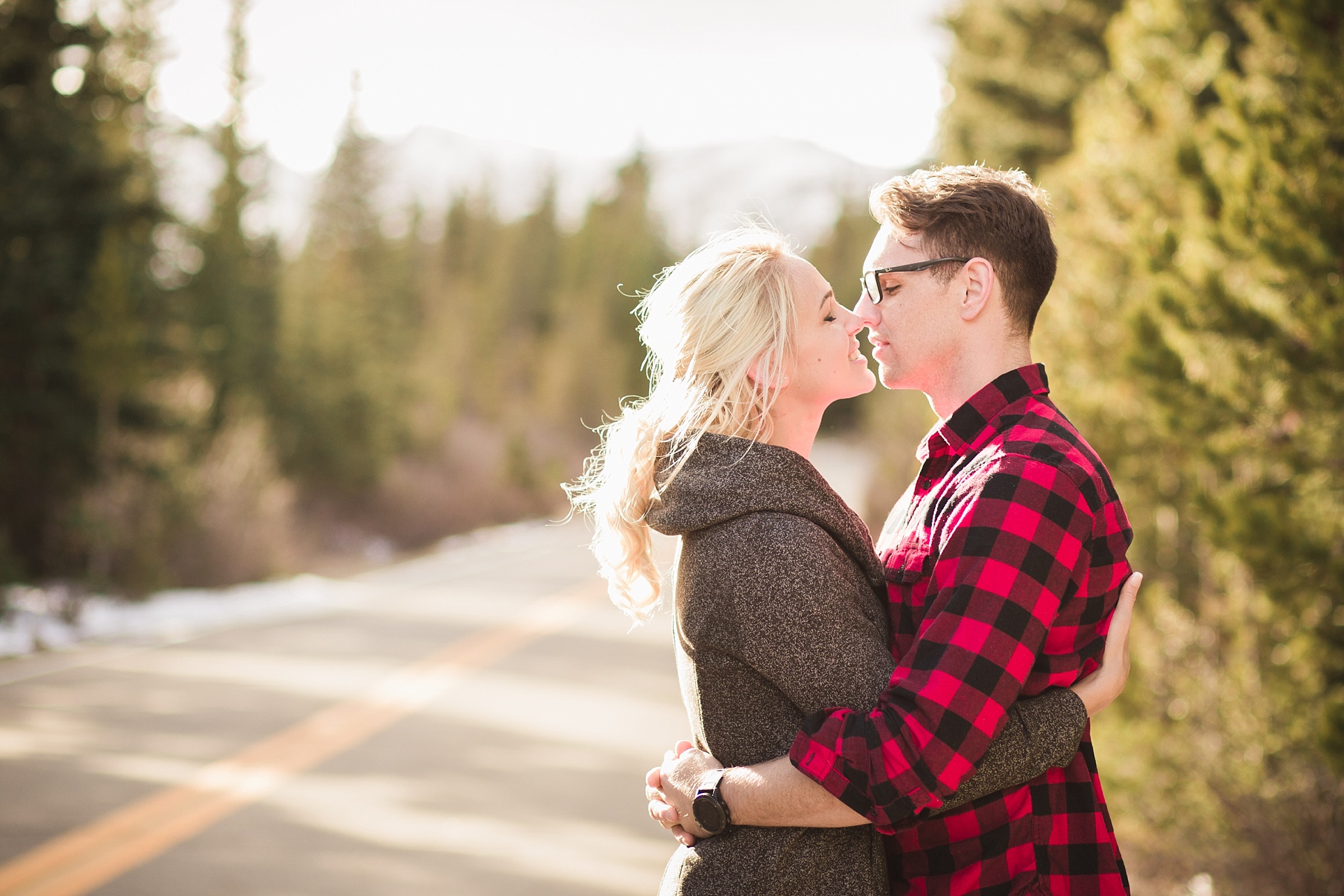 Couple kissing on a mountain road at sunset during their engagement session. Amy & Jonathan’s Brainard Lake Winter Engagement Session by Colorado Engagement Photographer, Jennifer Garza. Colorado Engagement Photographer, Colorado Engagement Photography, Brainard Lake Engagement Session, Brainard Lake Engagement Photos, Mountain Engagement Session, Colorado Winter Engagement Photos, Winter Engagement Photography, Mountain Engagement Photographer, Colorado Wedding, Colorado Bride