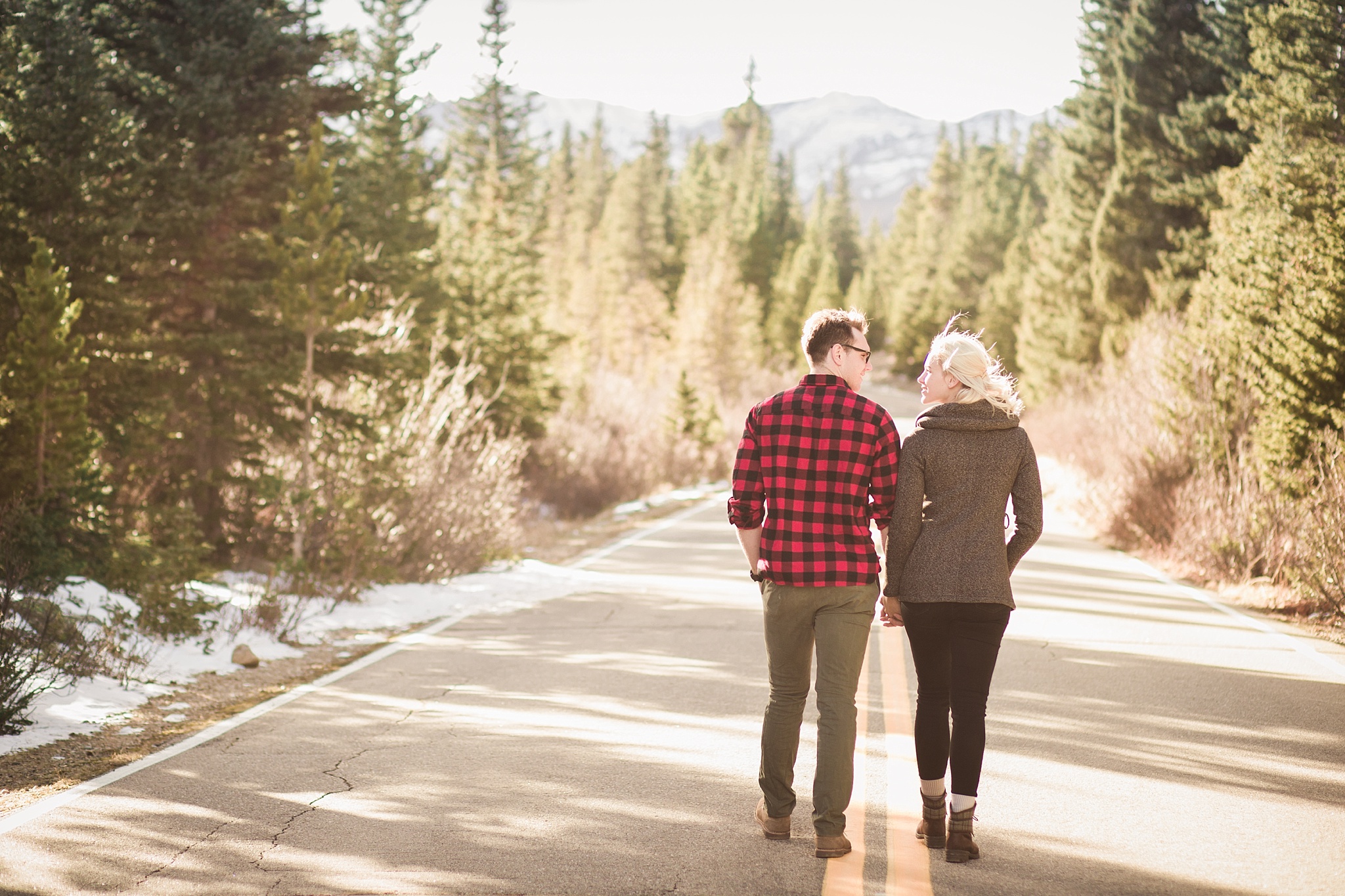 Couple walking together down a mountain road at sunset during their engagement session. Amy & Jonathan’s Brainard Lake Winter Engagement Session by Colorado Engagement Photographer, Jennifer Garza. Colorado Engagement Photographer, Colorado Engagement Photography, Brainard Lake Engagement Session, Brainard Lake Engagement Photos, Mountain Engagement Session, Colorado Winter Engagement Photos, Winter Engagement Photography, Mountain Engagement Photographer, Colorado Wedding, Colorado Bride