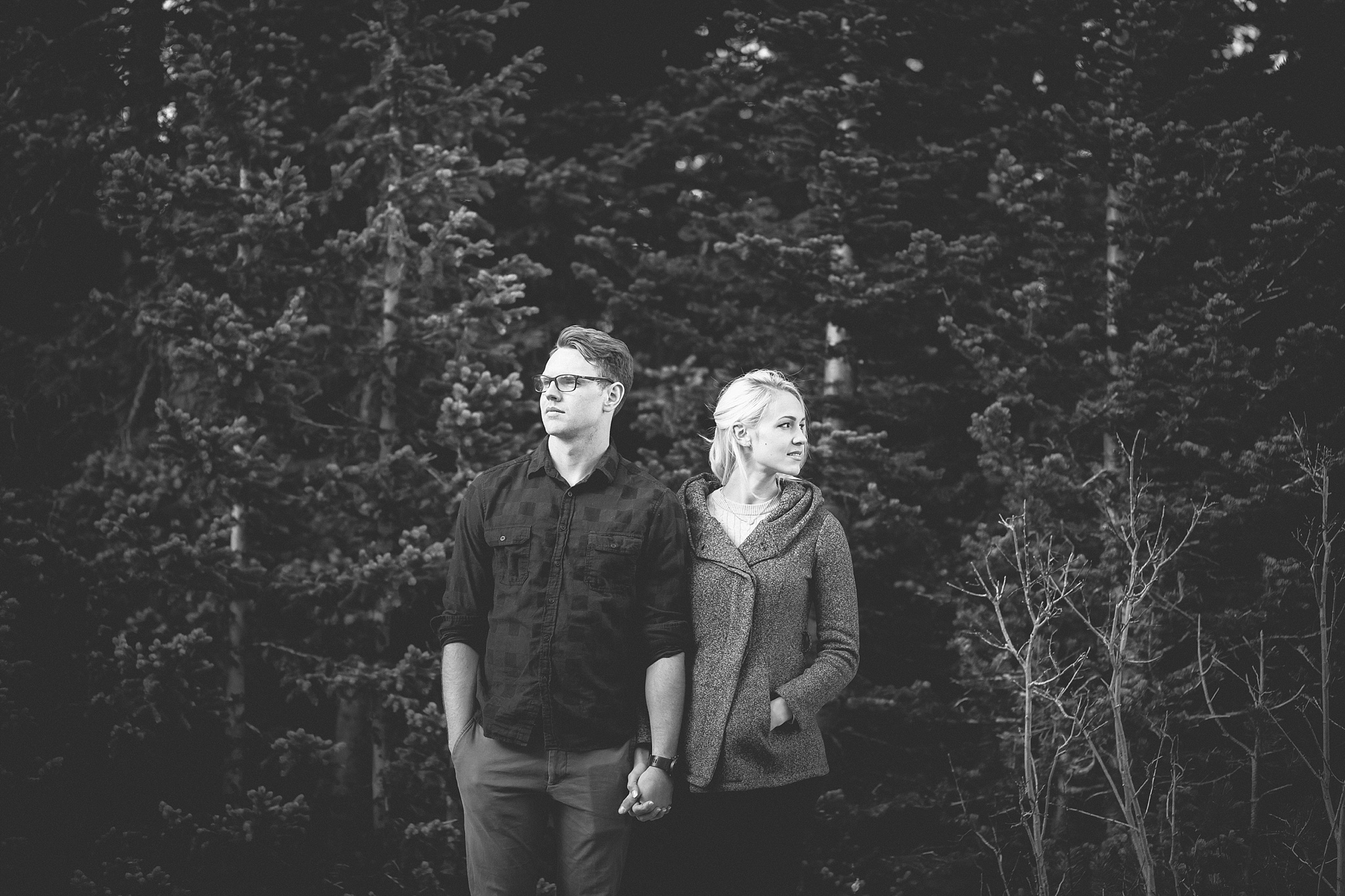 Moody couple standing among the trees during their mountain engagement session. Amy & Jonathan’s Brainard Lake Winter Engagement Session by Colorado Engagement Photographer, Jennifer Garza. Colorado Engagement Photographer, Colorado Engagement Photography, Brainard Lake Engagement Session, Brainard Lake Engagement Photos, Mountain Engagement Session, Colorado Winter Engagement Photos, Winter Engagement Photography, Mountain Engagement Photographer, Colorado Wedding, Colorado Bride, MagMod