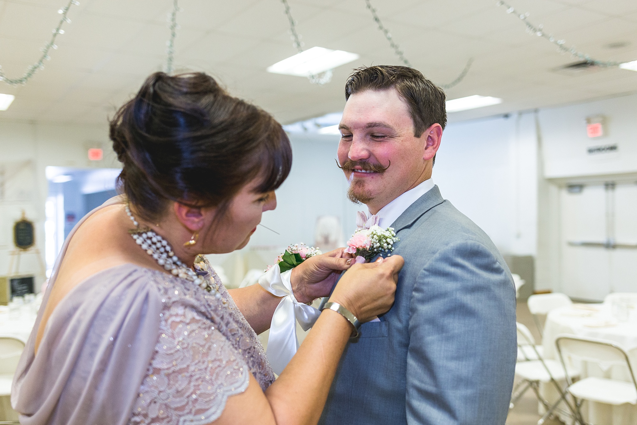 Mother pinning on the groom’s boutonniere. Katie & Jake’s Castle Rock Wedding at the Douglas County Fairgrounds by Colorado Wedding Photographer, Jennifer Garza. Colorado Wedding Photographer, Colorado Wedding Photography, Douglas County Fairgrounds Wedding Photography, Castle Rock Wedding Photography, Castle Rock Wedding Photographer, Colorado Wedding Photography, Colorado Wedding Photographer, Colorado Wedding, Rustic Wedding, Colorado Bride, Rocky Mountain Bride