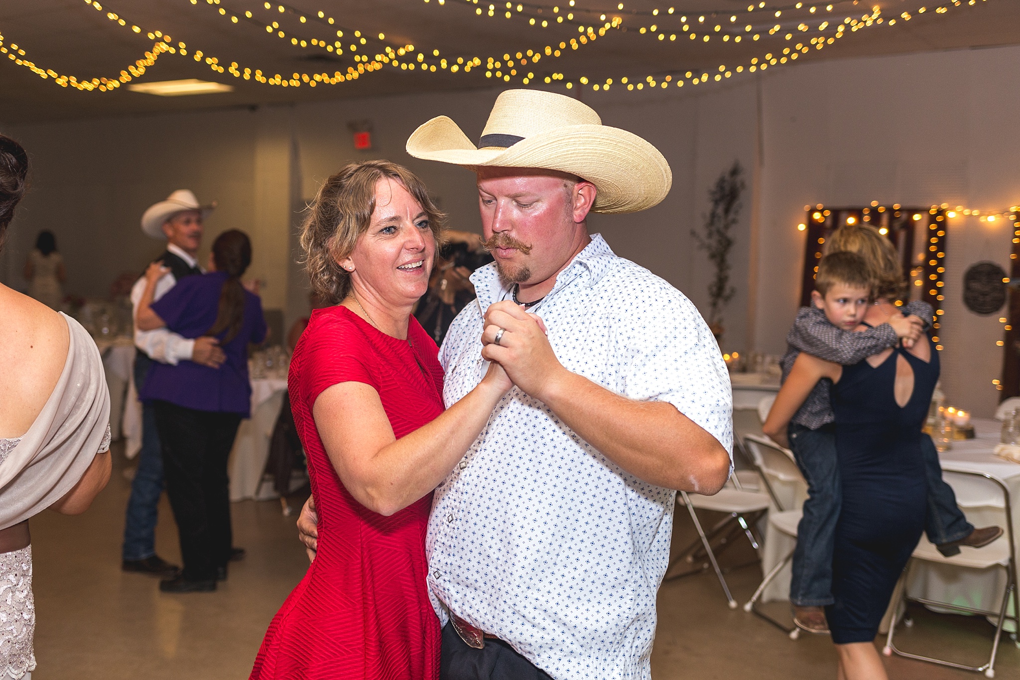 Guests dancing during their wedding reception. Katie & Jake’s Castle Rock Wedding at the Douglas County Fairgrounds by Colorado Wedding Photographer, Jennifer Garza. Colorado Wedding Photographer, Colorado Wedding Photography, Douglas County Fairgrounds Wedding Photography, Castle Rock Wedding Photography, Castle Rock Wedding Photographer, Colorado Wedding Photography, Colorado Wedding Photographer, Colorado Wedding, Rustic Wedding, Colorado Bride, Rocky Mountain Bride