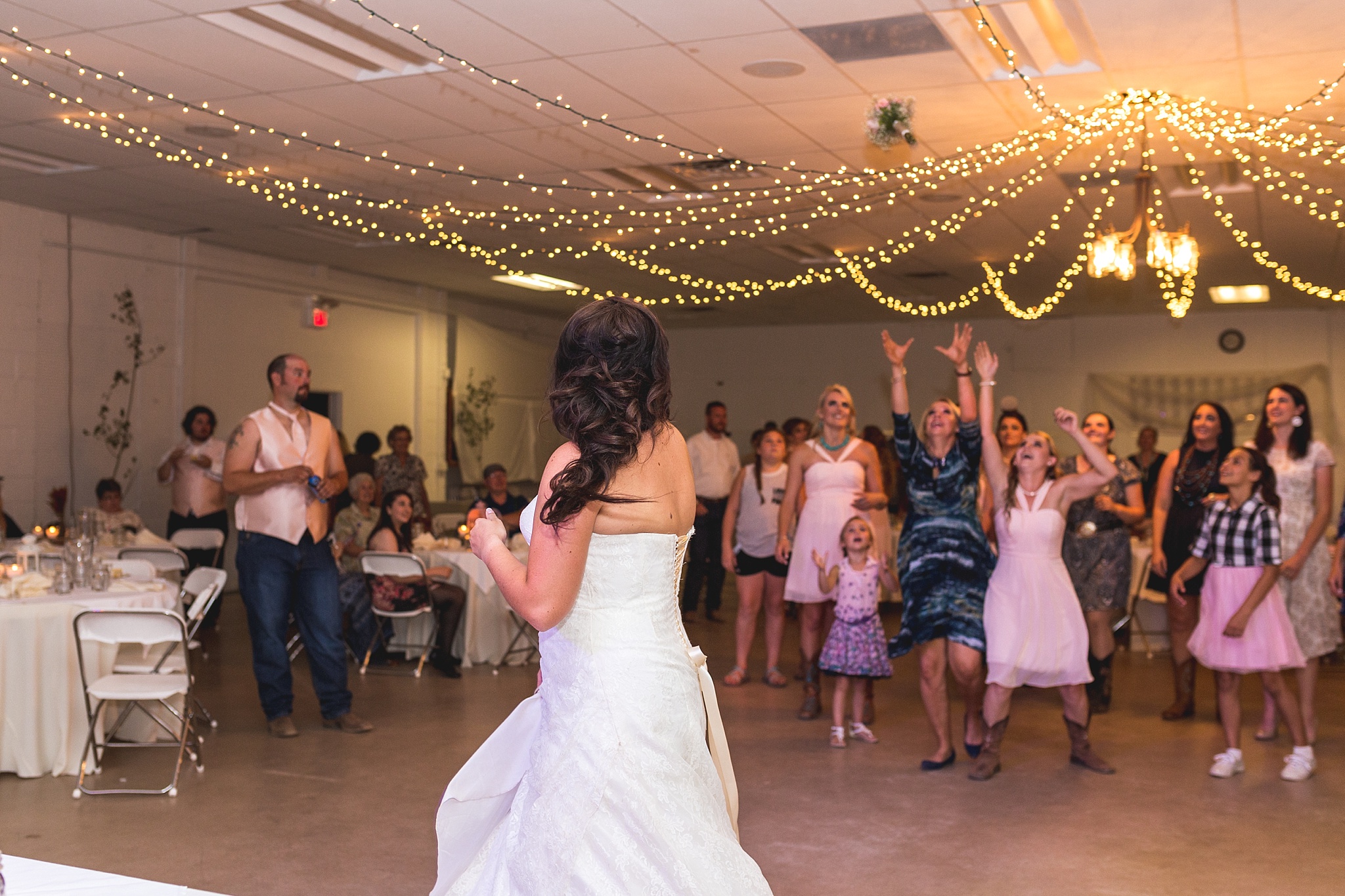 Bride throwing the bouquet at wedding reception. Katie & Jake’s Castle Rock Wedding at the Douglas County Fairgrounds by Colorado Wedding Photographer, Jennifer Garza. Colorado Wedding Photographer, Colorado Wedding Photography, Douglas County Fairgrounds Wedding Photography, Castle Rock Wedding Photography, Castle Rock Wedding Photographer, Colorado Wedding Photography, Colorado Wedding Photographer, Colorado Wedding, Rustic Wedding, Colorado Bride, Rocky Mountain Bride