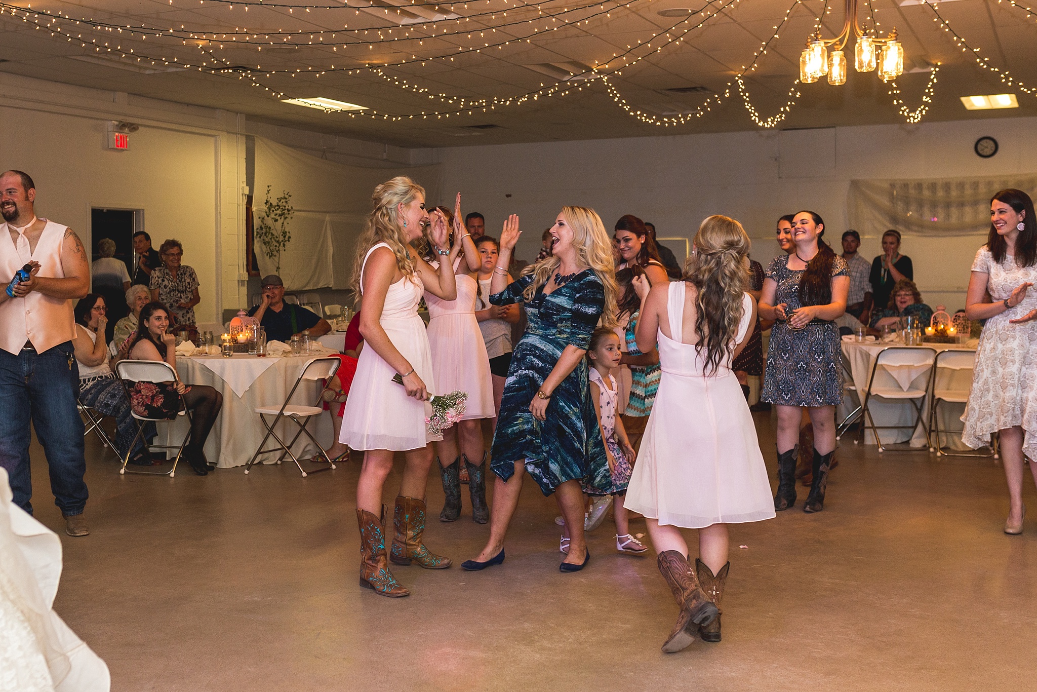 Bridesmaids catching the bouquet at wedding reception. Katie & Jake’s Castle Rock Wedding at the Douglas County Fairgrounds by Colorado Wedding Photographer, Jennifer Garza. Colorado Wedding Photographer, Colorado Wedding Photography, Douglas County Fairgrounds Wedding Photography, Castle Rock Wedding Photography, Castle Rock Wedding Photographer, Colorado Wedding Photography, Colorado Wedding Photographer, Colorado Wedding, Rustic Wedding, Colorado Bride, Rocky Mountain Bride