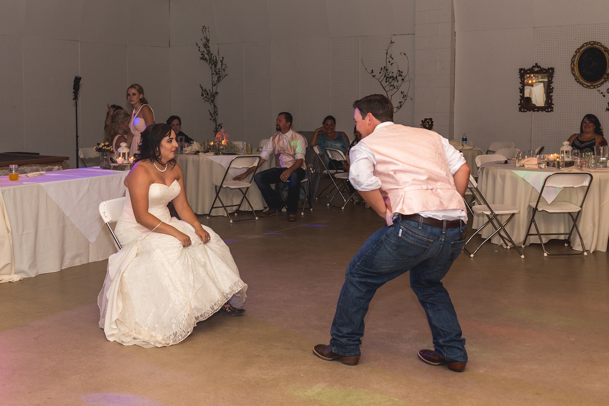 Groom getting the garter at wedding reception. Katie & Jake’s Castle Rock Wedding at the Douglas County Fairgrounds by Colorado Wedding Photographer, Jennifer Garza. Colorado Wedding Photographer, Colorado Wedding Photography, Douglas County Fairgrounds Wedding Photography, Castle Rock Wedding Photography, Castle Rock Wedding Photographer, Colorado Wedding Photography, Colorado Wedding Photographer, Colorado Wedding, Rustic Wedding, Colorado Bride, Rocky Mountain Bride