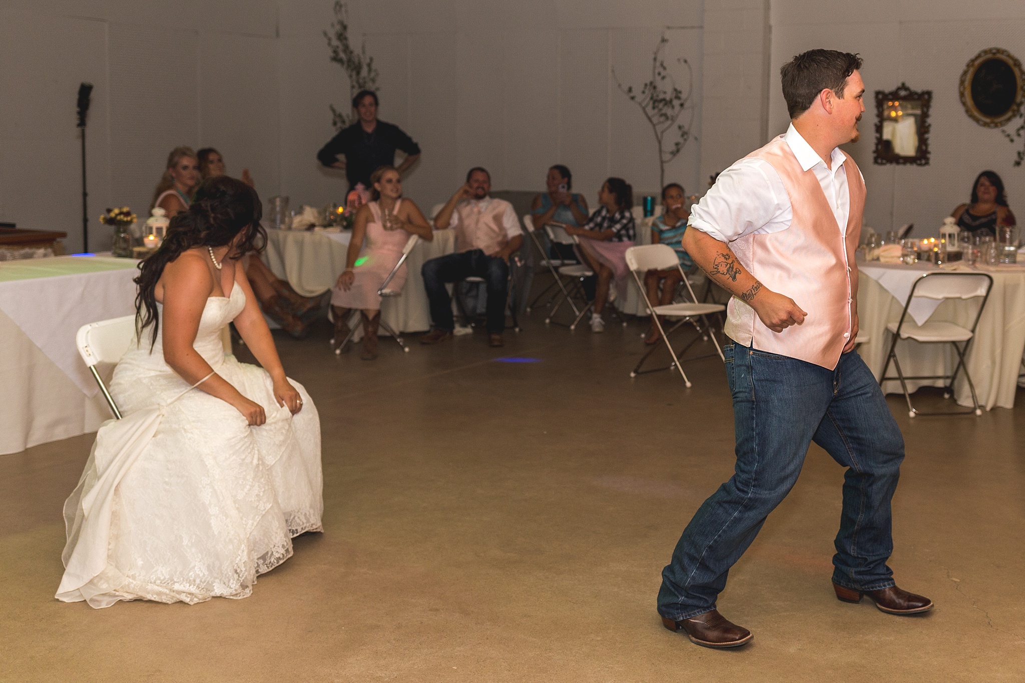 Groom getting the garter at wedding reception. Katie & Jake’s Castle Rock Wedding at the Douglas County Fairgrounds by Colorado Wedding Photographer, Jennifer Garza. Colorado Wedding Photographer, Colorado Wedding Photography, Douglas County Fairgrounds Wedding Photography, Castle Rock Wedding Photography, Castle Rock Wedding Photographer, Colorado Wedding Photography, Colorado Wedding Photographer, Colorado Wedding, Rustic Wedding, Colorado Bride, Rocky Mountain Bride