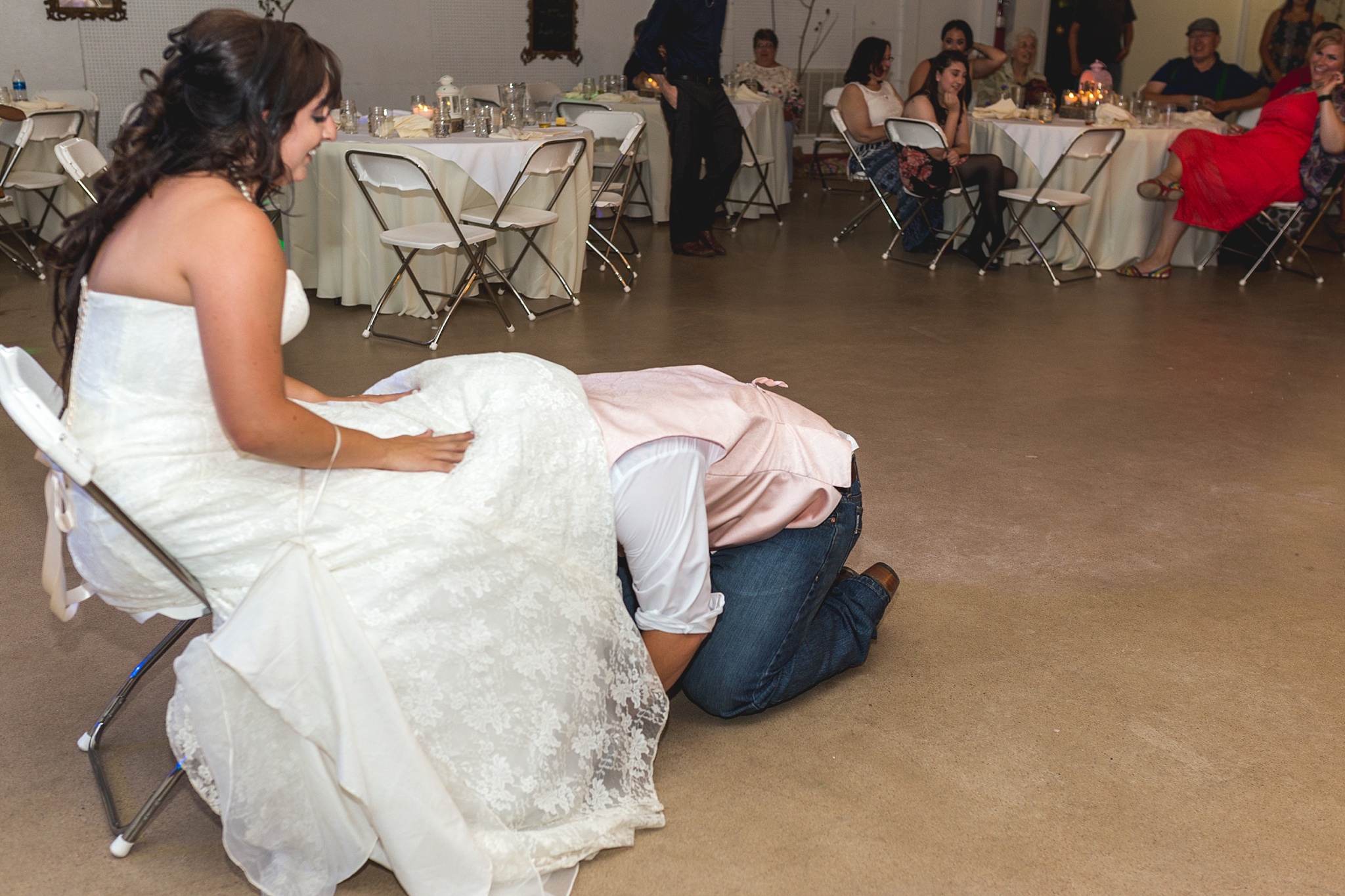 Groom getting the garter at wedding reception. Katie & Jake’s Castle Rock Wedding at the Douglas County Fairgrounds by Colorado Wedding Photographer, Jennifer Garza. Colorado Wedding Photographer, Colorado Wedding Photography, Douglas County Fairgrounds Wedding Photography, Castle Rock Wedding Photography, Castle Rock Wedding Photographer, Colorado Wedding Photography, Colorado Wedding Photographer, Colorado Wedding, Rustic Wedding, Colorado Bride, Rocky Mountain Bride