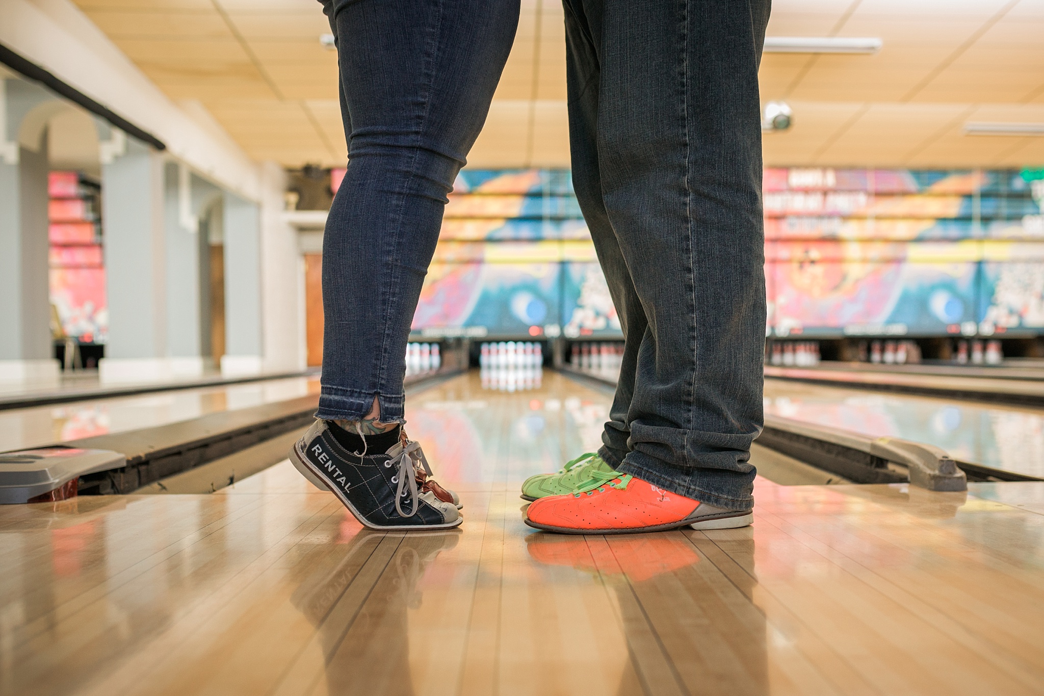 Couple standing in the bowling lane during their bowling alley engagement session. Briana & Kevin’s Devil’s Backbone and Sweetheart Lanes Engagement Session by Colorado Engagement Photographer, Jennifer Garza. Devil's Backbone Engagement, Devil's Backbone Engagement Session, Loveland Engagement Session, Colorado Engagement Photography, Colorado Engagement Photos, Sweetheart Lanes Bowling Alley, Bowling Alley Engagement, Bowling Engagement Session, Bowling Engagement Photography, Wedding Inspo, Colorado Wedding, Colorado Bride, Brides of Colorado, Bride to Be, Couples Goals