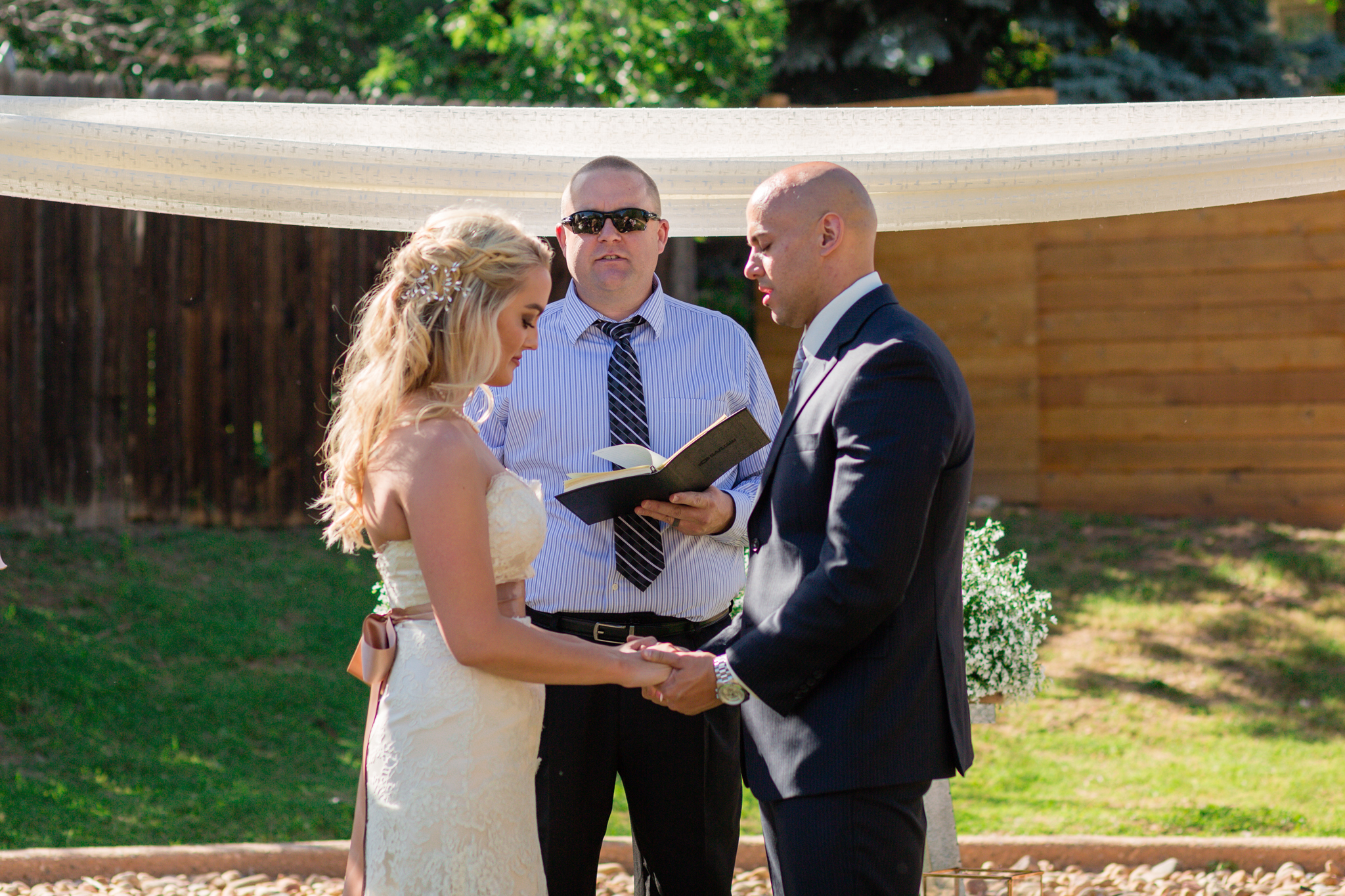 Bride and Groom holding hands at the beginning ceremony. Kyley & Brian's Boulder Backyard Wedding and The Mediterranean Restaurant Reception by Colorado Wedding Photographer, Jennifer Garza. Colorado Wedding Photographer, Colorado Wedding Photography, Colorado Top Wedding Photographer, Boulder Wedding Photographer, Boulder Wedding, Backyard Wedding Photographer, Backyard Wedding, The Mediterranean Restaurant, The Med, The Med Reception, Intimate Wedding, Small Intimate Wedding, Rocky Mountain Wedding, Rocky Mountain Bride, Colorado Bride, Here Comes the Bride, Couples Goals, Brides of Colorado