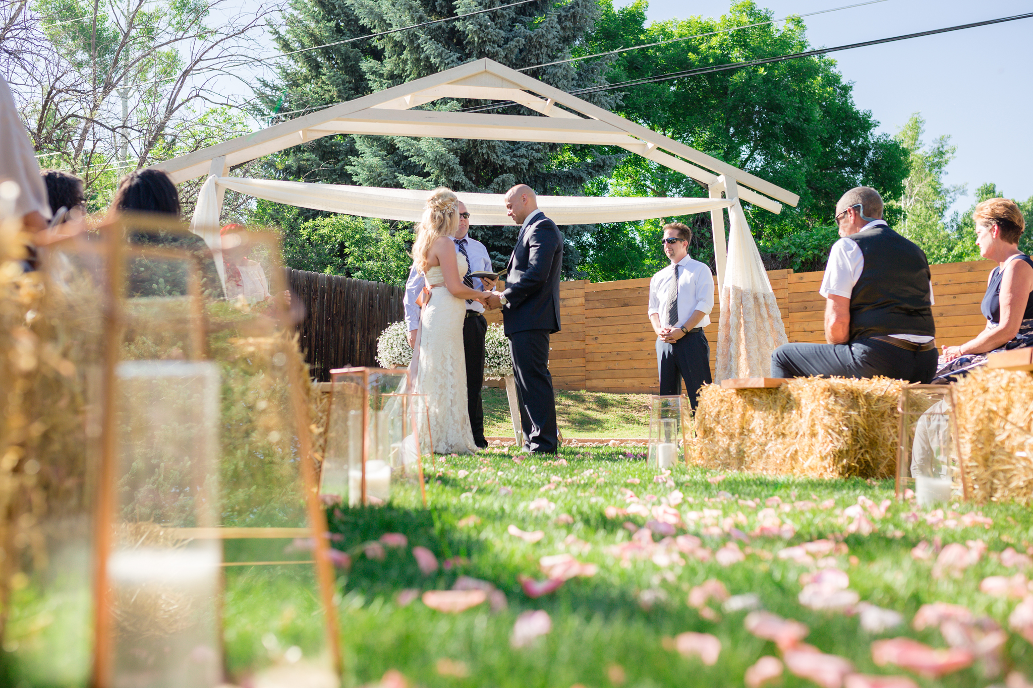 Bride and Groom holding hands at the beginning ceremony. Kyley & Brian's Boulder Backyard Wedding and The Mediterranean Restaurant Reception by Colorado Wedding Photographer, Jennifer Garza. Colorado Wedding Photographer, Colorado Wedding Photography, Colorado Top Wedding Photographer, Boulder Wedding Photographer, Boulder Wedding, Backyard Wedding Photographer, Backyard Wedding, The Mediterranean Restaurant, The Med, The Med Reception, Intimate Wedding, Small Intimate Wedding, Rocky Mountain Wedding, Rocky Mountain Bride, Colorado Bride, Here Comes the Bride, Couples Goals, Brides of Colorado