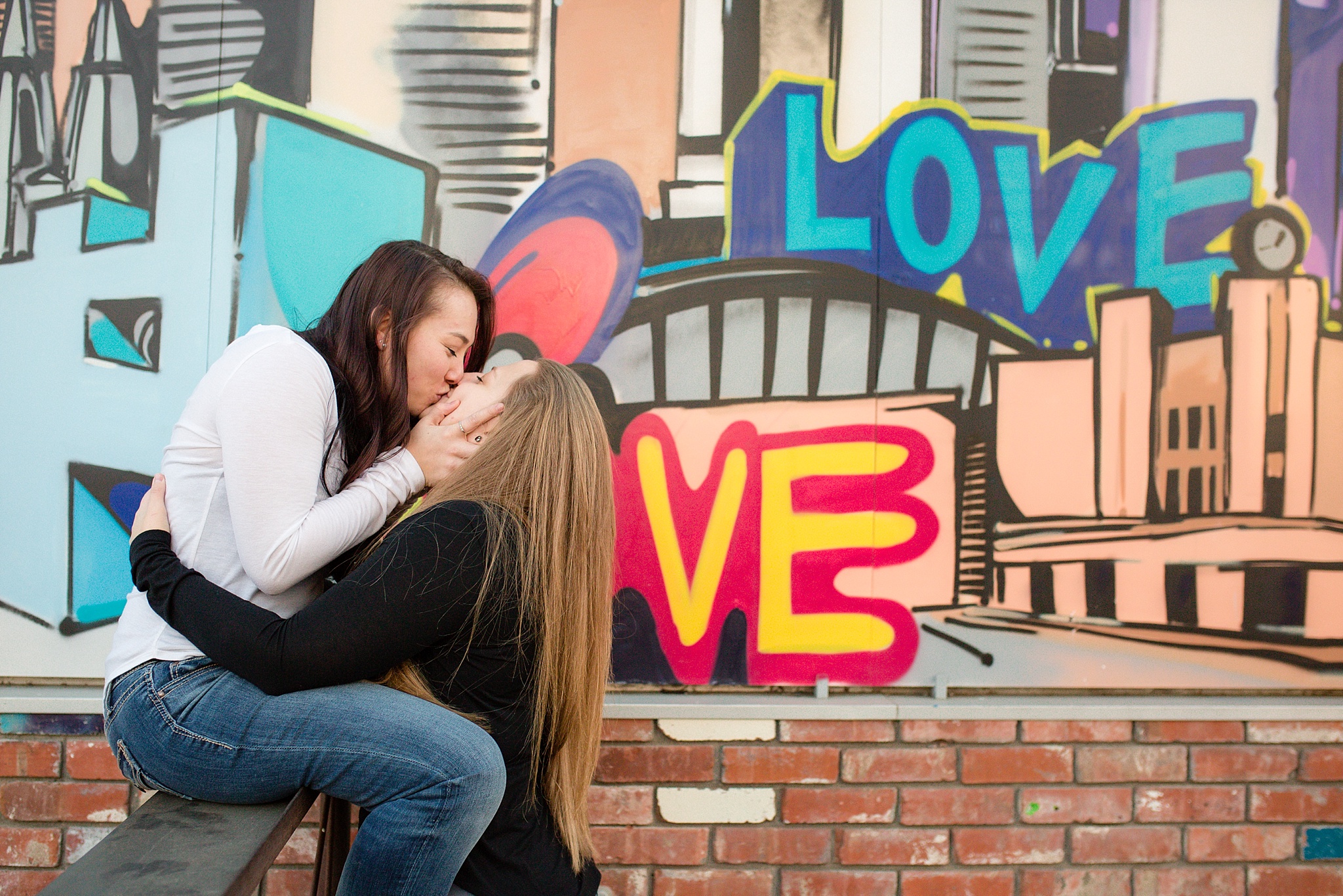 Same-Sex Couple kissing in front of a mural. Jessica & Caity’s Same-Sex Engagement Session at 10 Barrel Brewery & RiNo District by Colorado Engagement Photographer, Jennifer Garza. 10 Barrel Brewery Engagement, Brewery Engagement Photos, RiNo District Engagement Photos, RiNo District, RiNo Engagement Photography, Denver Engagement Photography, Denver Engagement, Colorado Engagement Photography, Urban Engagement Photos, Same-Sex Engagement Photography, Same-Sex Engagement Photos, Same Sex Marriage, Love is Love, LGBTQ