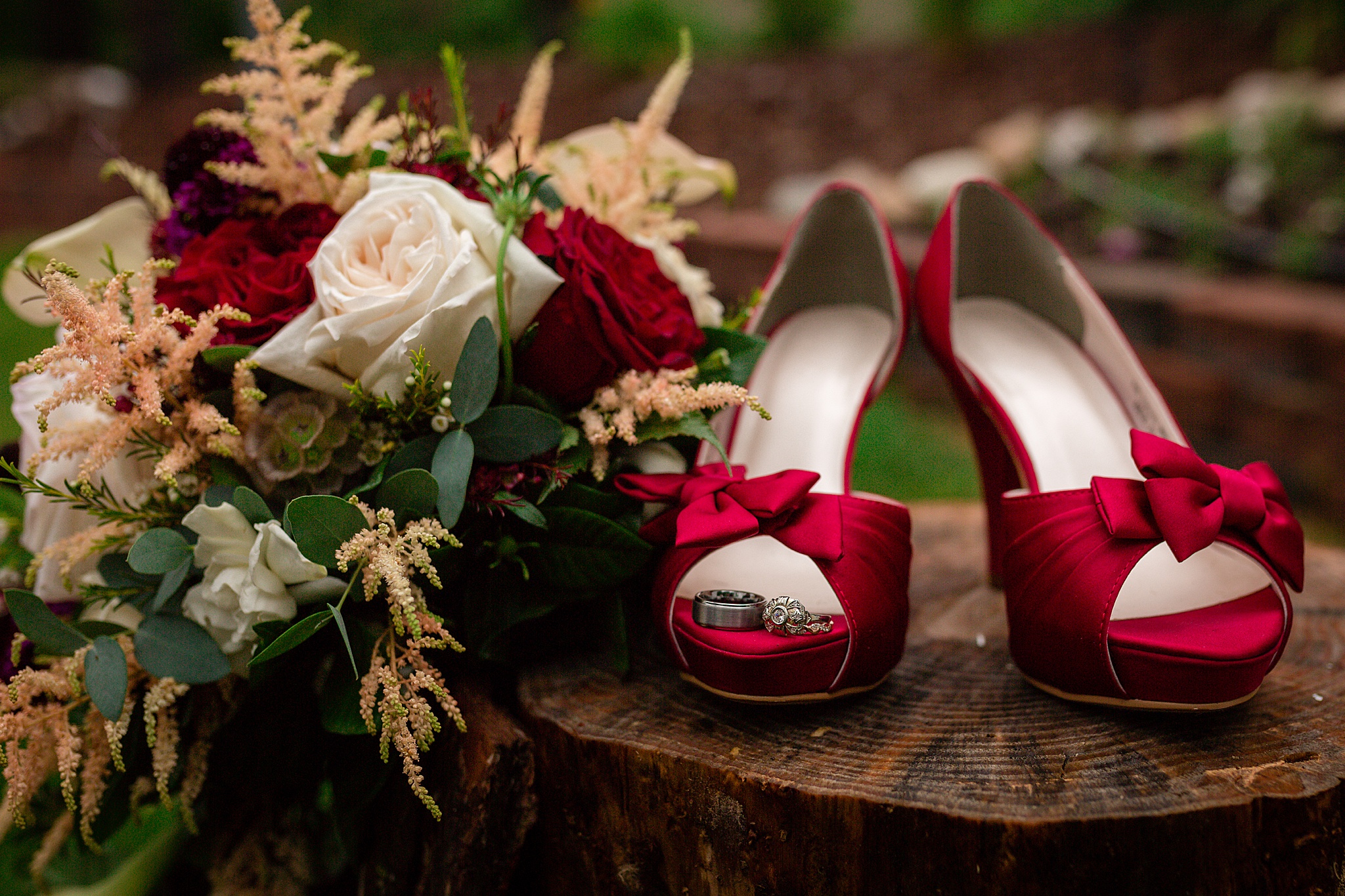 Close-up photo of wedding rings, red high heels, and bridal bouquet. Tania & Chris' Denver Wedding at the Wedgewood Ken Caryl by Colorado Wedding Photography, Jennifer Garza. Colorado Wedding Photographer, Colorado Wedding Photography, Denver Wedding Photographer, Denver Wedding Photography, US Marine Corp Wedding, US Marine Corp, Military Wedding, US Marines, Wedgewood Weddings, Wedgewood Weddings Ken Caryl, Colorado Wedding, Denver Wedding, Wedding Photographer, Colorado Bride
