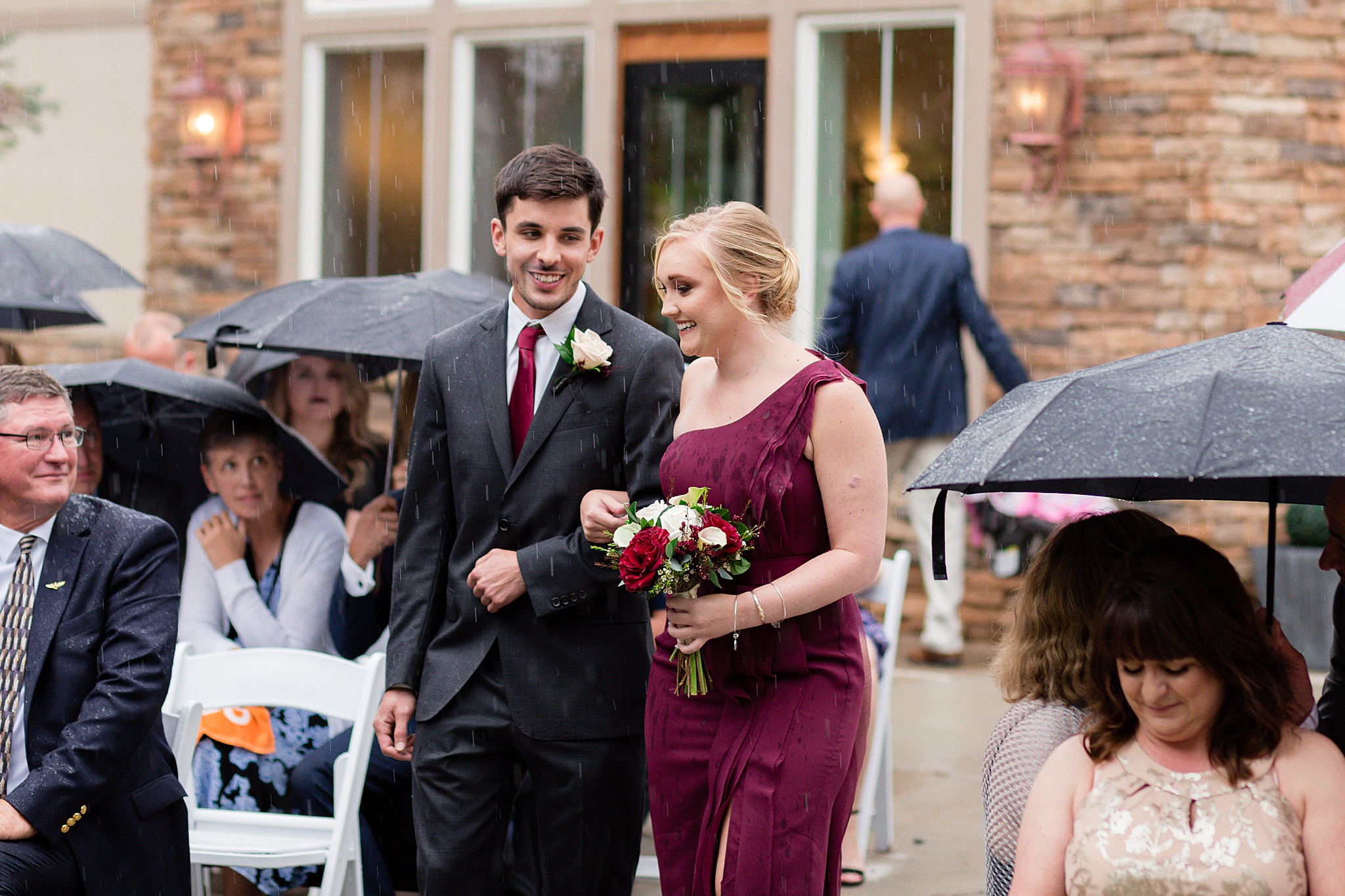 Bridal party walking down the aisle at a rainy summer wedding. Tania & Chris' Denver Wedding at the Wedgewood Ken Caryl by Colorado Wedding Photography, Jennifer Garza. Colorado Wedding Photographer, Colorado Wedding Photography, Denver Wedding Photographer, Denver Wedding Photography, US Marine Corp Wedding, US Marine Corp, Military Wedding, US Marines, Wedgewood Weddings, Wedgewood Weddings Ken Caryl, Colorado Wedding, Denver Wedding, Wedding Photographer, Colorado Bride, Brides of Colorado