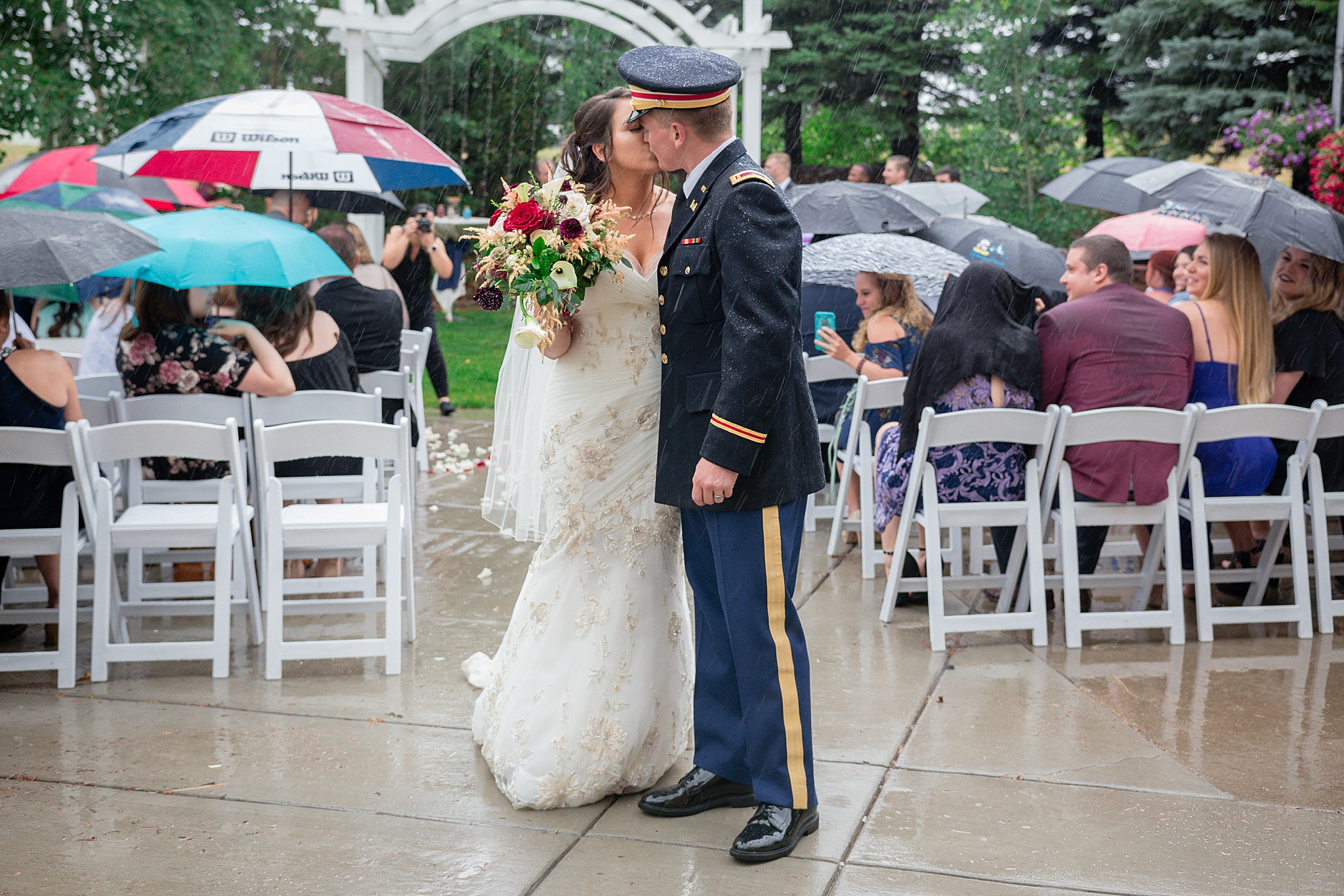 Bride & Groom kissing during a rainy summer wedding. Tania & Chris' Denver Wedding at the Wedgewood Ken Caryl by Colorado Wedding Photography, Jennifer Garza. Colorado Wedding Photographer, Colorado Wedding Photography, Denver Wedding Photographer, Denver Wedding Photography, US Marine Corp Wedding, US Marine Corp, Military Wedding, US Marines, Wedgewood Weddings, Wedgewood Weddings Ken Caryl, Colorado Wedding, Denver Wedding, Wedding Photographer, Colorado Bride, Brides of Colorado