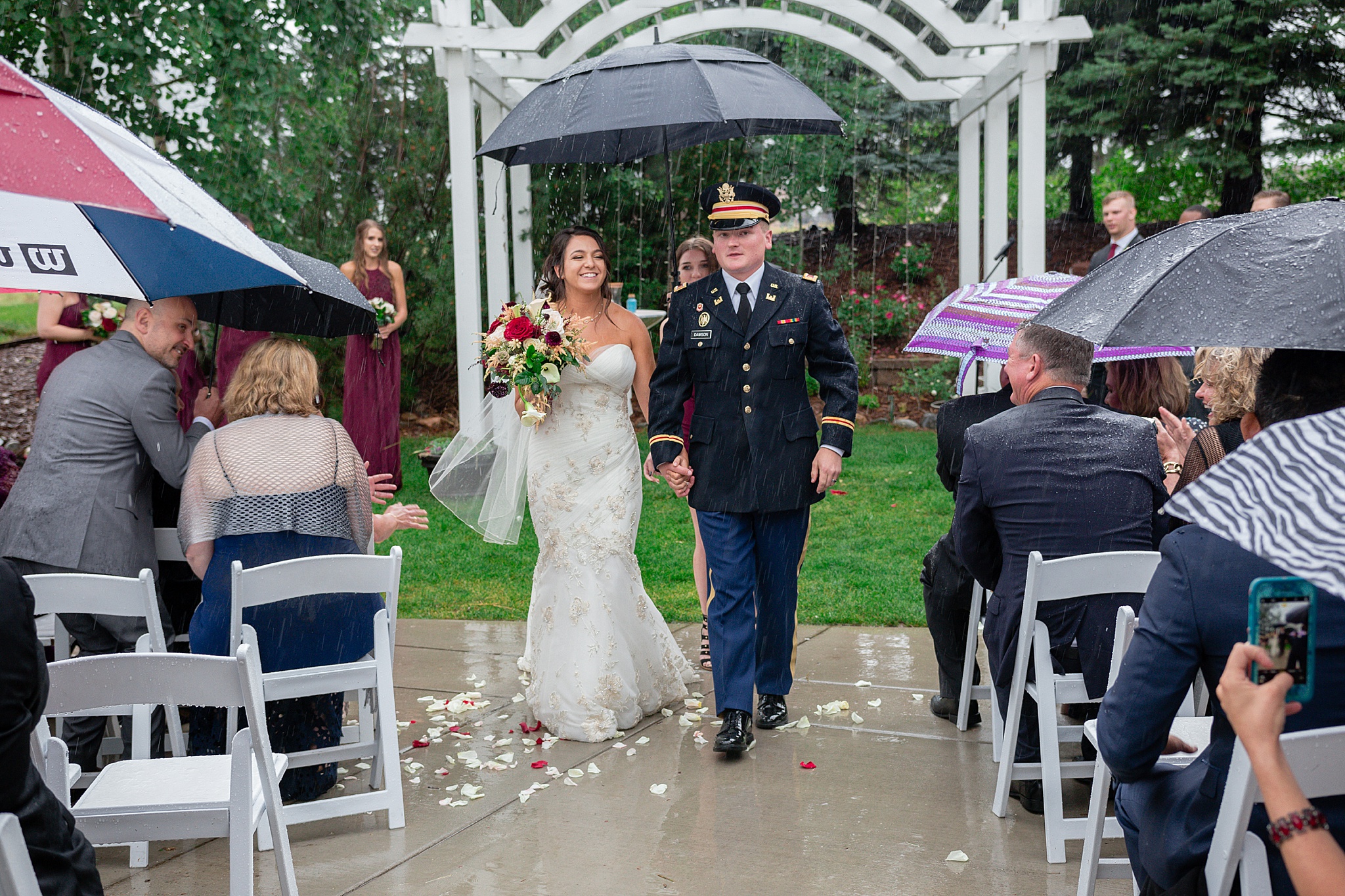 Bride & Groom walking up the aisle during a rainy summer wedding. Tania & Chris' Denver Wedding at the Wedgewood Ken Caryl by Colorado Wedding Photography, Jennifer Garza. Colorado Wedding Photographer, Colorado Wedding Photography, Denver Wedding Photographer, Denver Wedding Photography, US Marine Corp Wedding, US Marine Corp, Military Wedding, US Marines, Wedgewood Weddings, Wedgewood Weddings Ken Caryl, Colorado Wedding, Denver Wedding, Wedding Photographer, Colorado Bride, Brides of Colorado