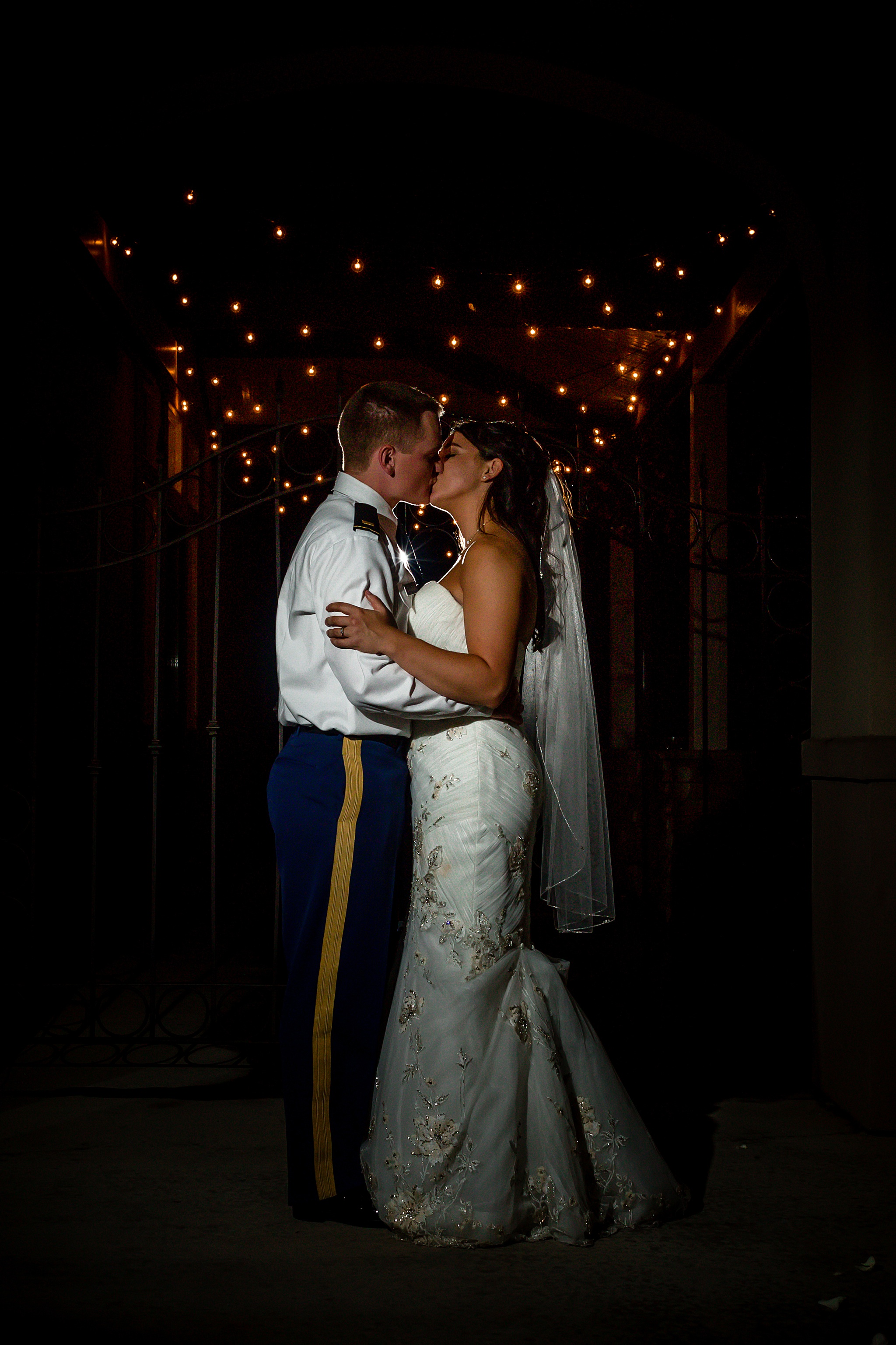 Bride & Groom kissing with string lights in the background. Tania & Chris' Denver Wedding at the Wedgewood Ken Caryl by Colorado Wedding Photography, Jennifer Garza. Colorado Wedding Photographer, Colorado Wedding Photography, Denver Wedding Photographer, Denver Wedding Photography, US Marine Corp Wedding, US Marine Corp, Military Wedding, US Marines, Wedgewood Weddings, Wedgewood Weddings Ken Caryl, Colorado Wedding, Denver Wedding, Wedding Photographer, Colorado Bride, Brides of Colorado