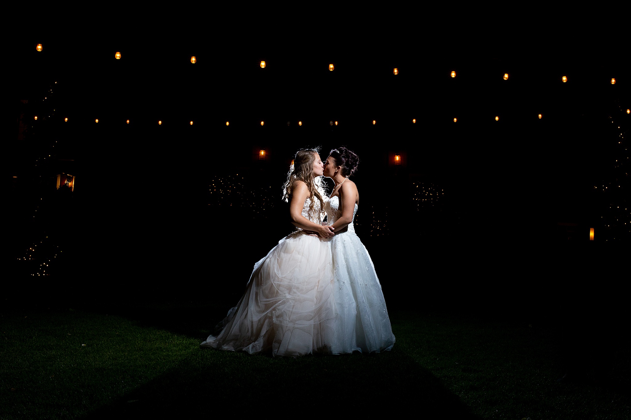 Bride & Bride kissing under string lights. Jessica & Caity’s Denver Same-Sex Wedding at The Barn at Raccoon Creek by Colorado Wedding Photographer, Jennifer Garza. Colorado Wedding Photographer, Colorado Wedding Photos, Denver Wedding Photos, Denver Wedding Photographer, The Barn at Raccoon Creek Weddings, Brides of Colorado, Rocky Mountain Bride, Same-Sex Wedding, LGBTQ Wedding, Love Is Love, Colorado Same-Sex Wedding, Colorado Gay Weddings, Colorado Lesbian Weddings, Same-Sex Marriage, Colorado Same-Sex Marriage