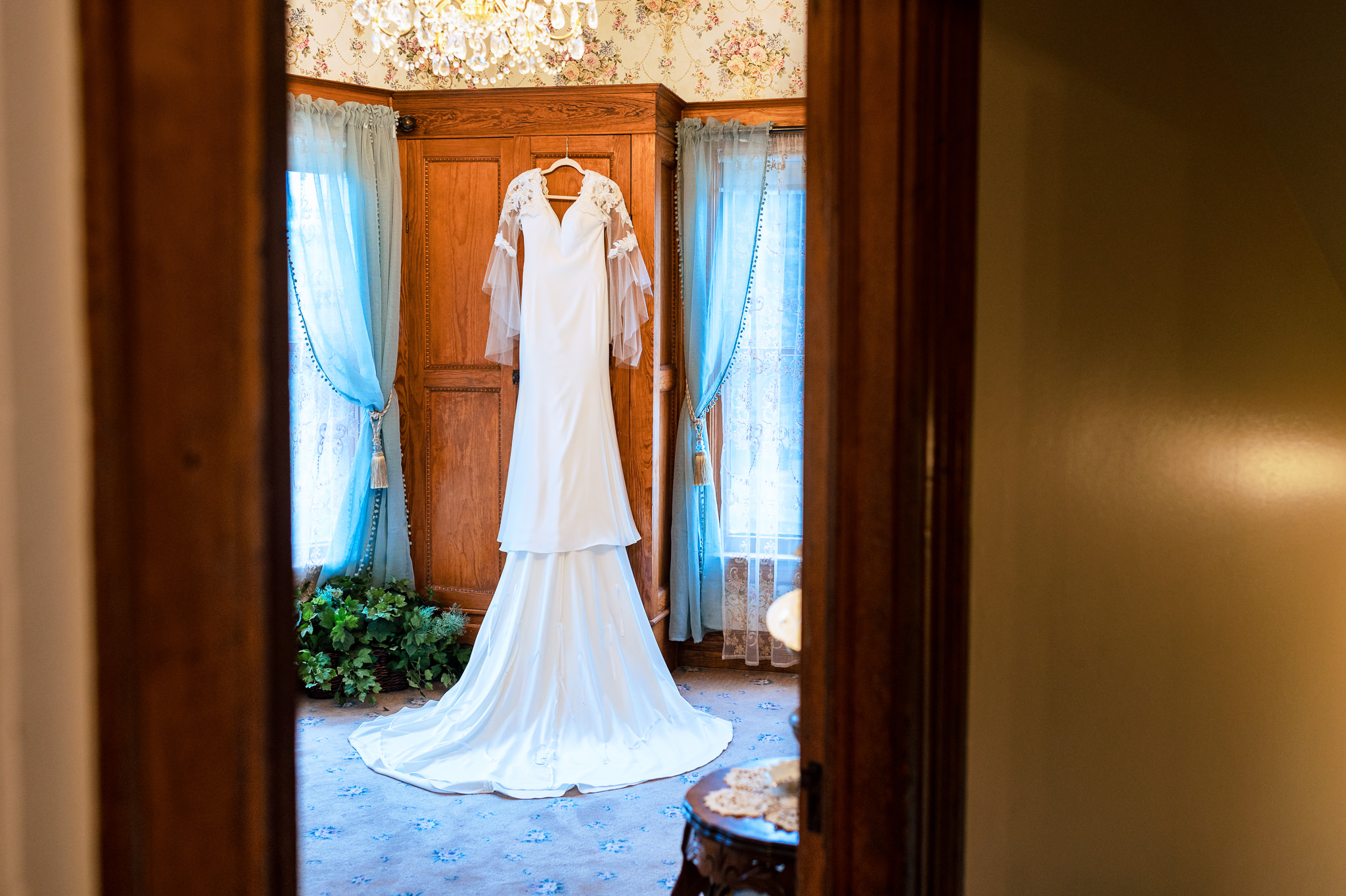 Wedding dress hanging in the bridal suite for Haley & Gytenis' Summer Wedding at The McCreery House by Colorado Wedding Photographer, Jennifer Garza.