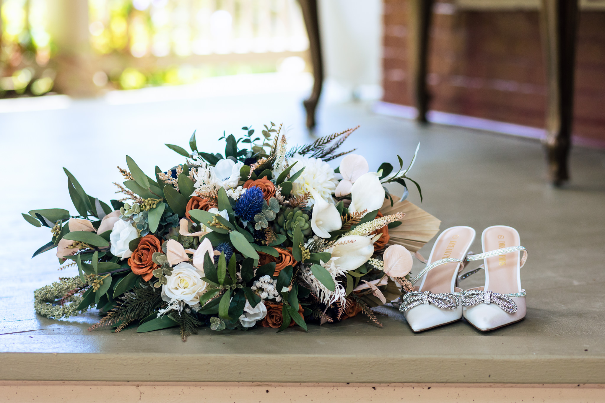 Photo of the bridal bouquet and bride's shoes for Haley & Gytenis' Summer Wedding at The McCreery House by Colorado Wedding Photographer, Jennifer Garza.