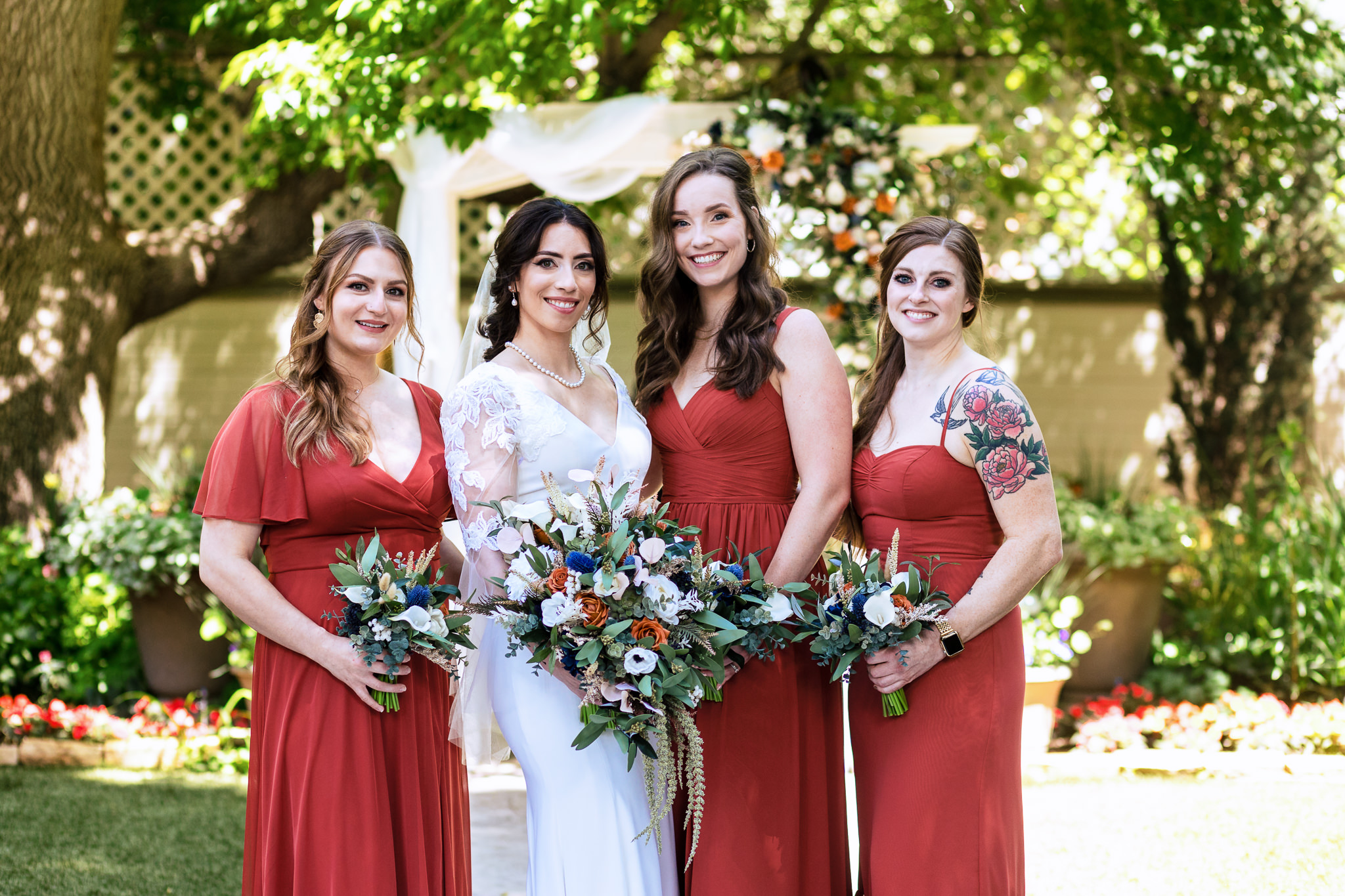 Photo of the Bride with her Bridesmaids out on the lawn for Haley & Gytenis' Summer Wedding at The McCreery House by Colorado Wedding Photographer, Jennifer Garza.