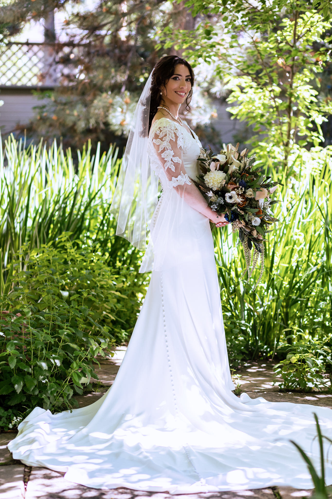 Photo of the bride in the garden for Haley & Gytenis' Summer Wedding at The McCreery House by Colorado Wedding Photographer, Jennifer Garza.