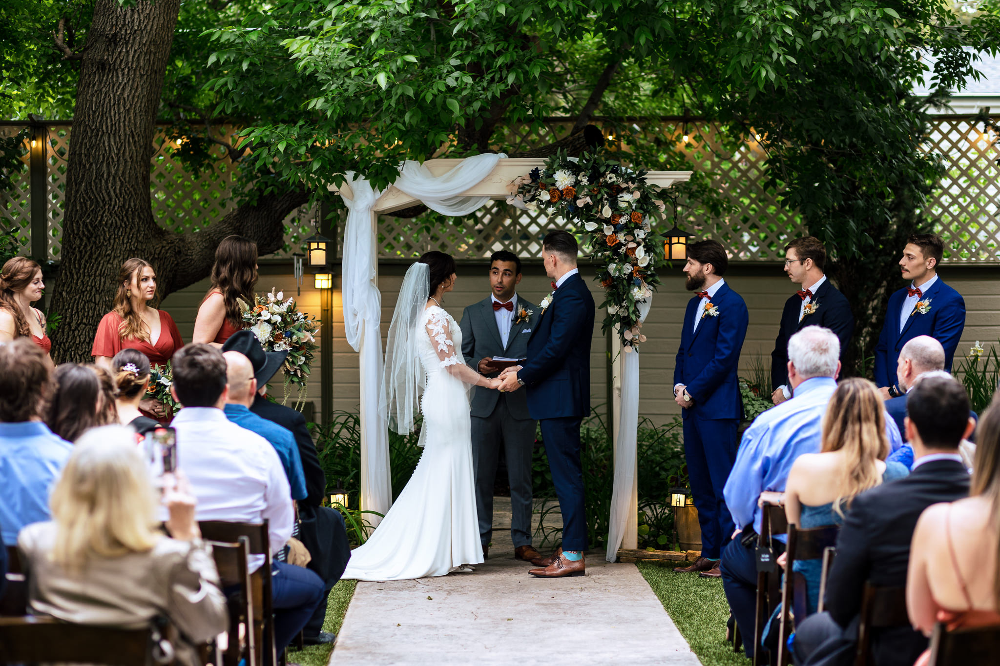 Bride & Groom holding hands while standing at the alter for Haley & Gytenis' Summer Wedding at The McCreery House by Colorado Wedding Photographer, Jennifer Garza.